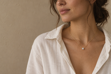 Illustrative portrait of a brunette wearing the Lumière pendant